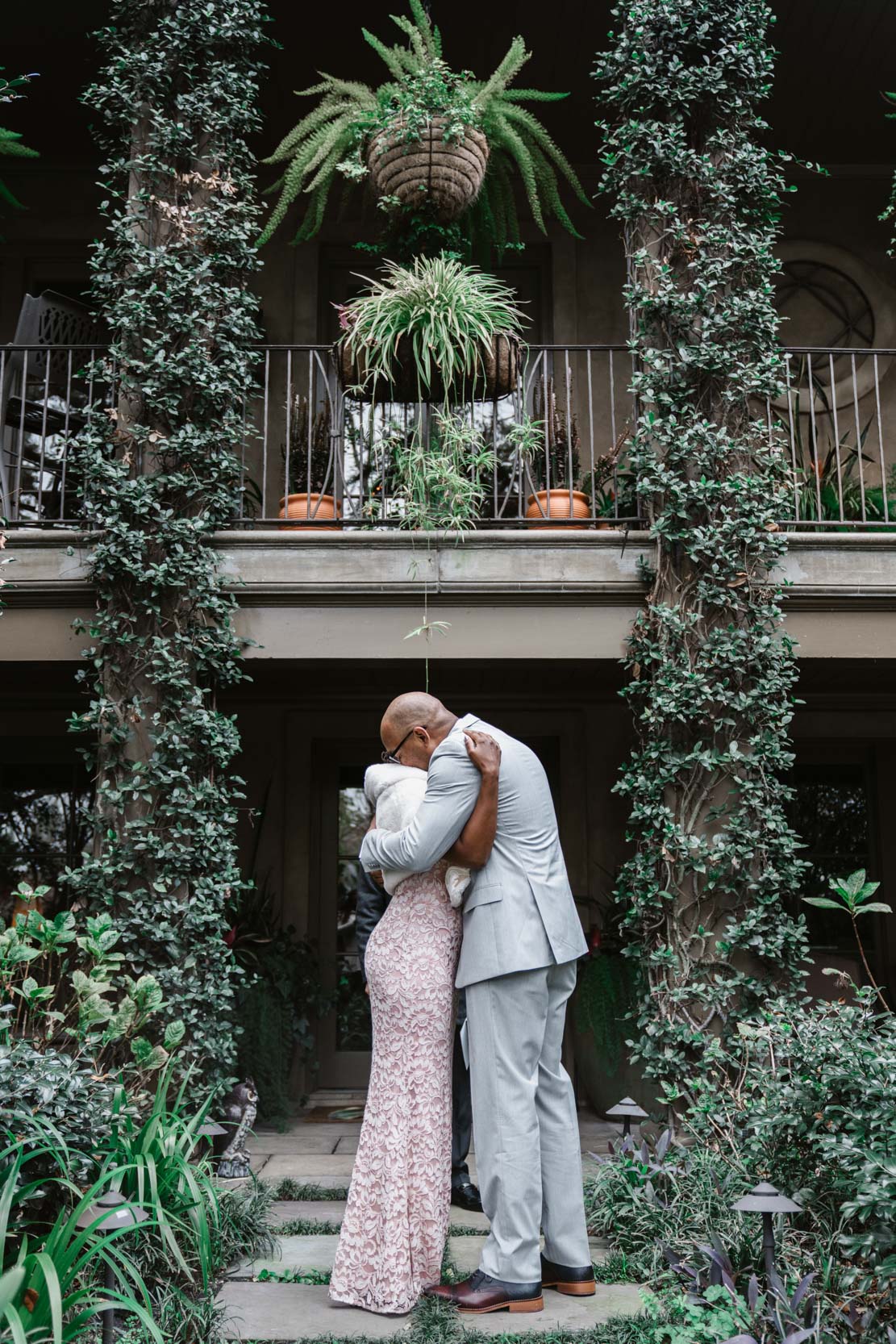 bride and groom kissing during the end of their wedding ceremony at Audubon Park in New Orleans