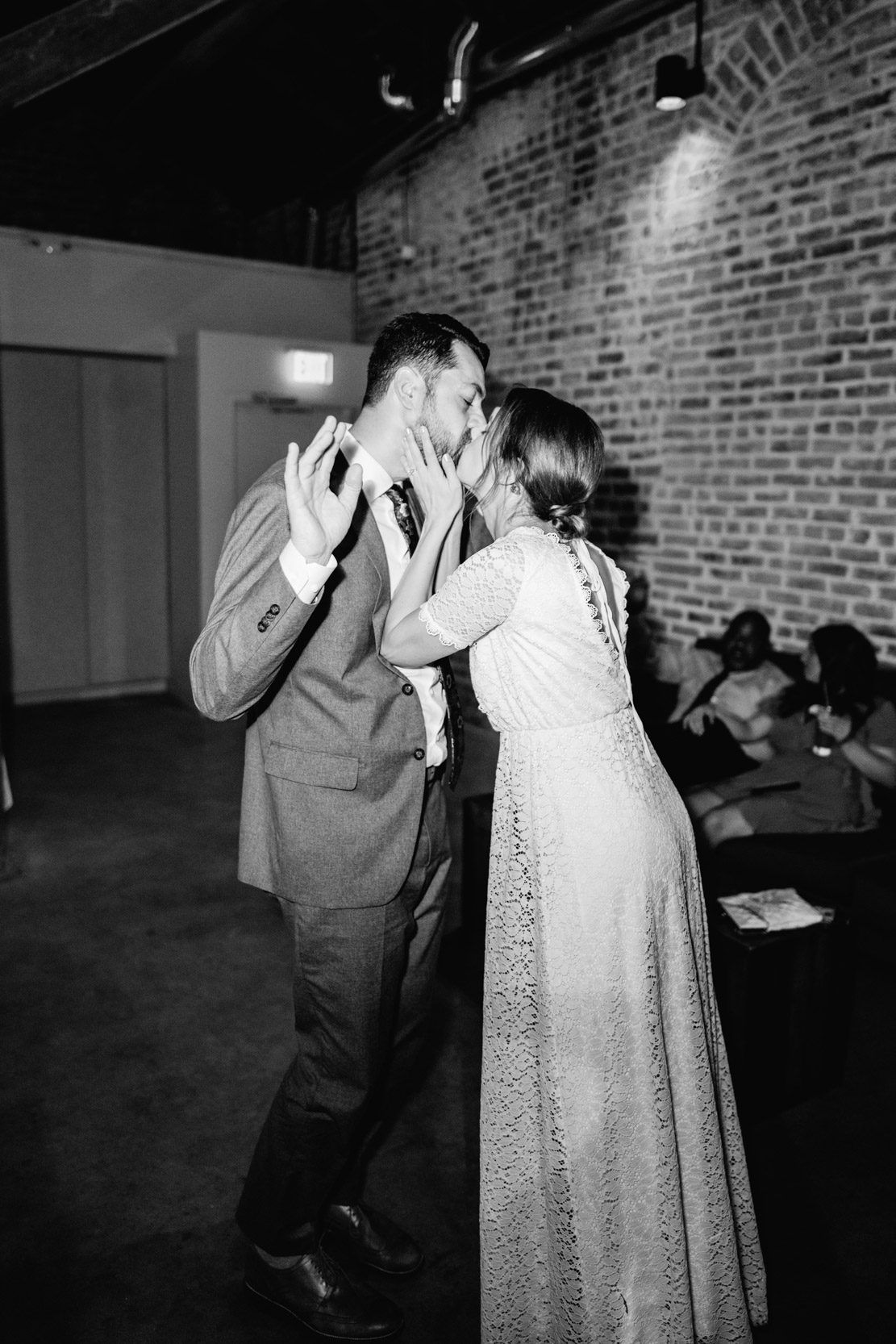 flash photo of bride and groom dancing and kissing during wedding reception at Capulet in New Orleans