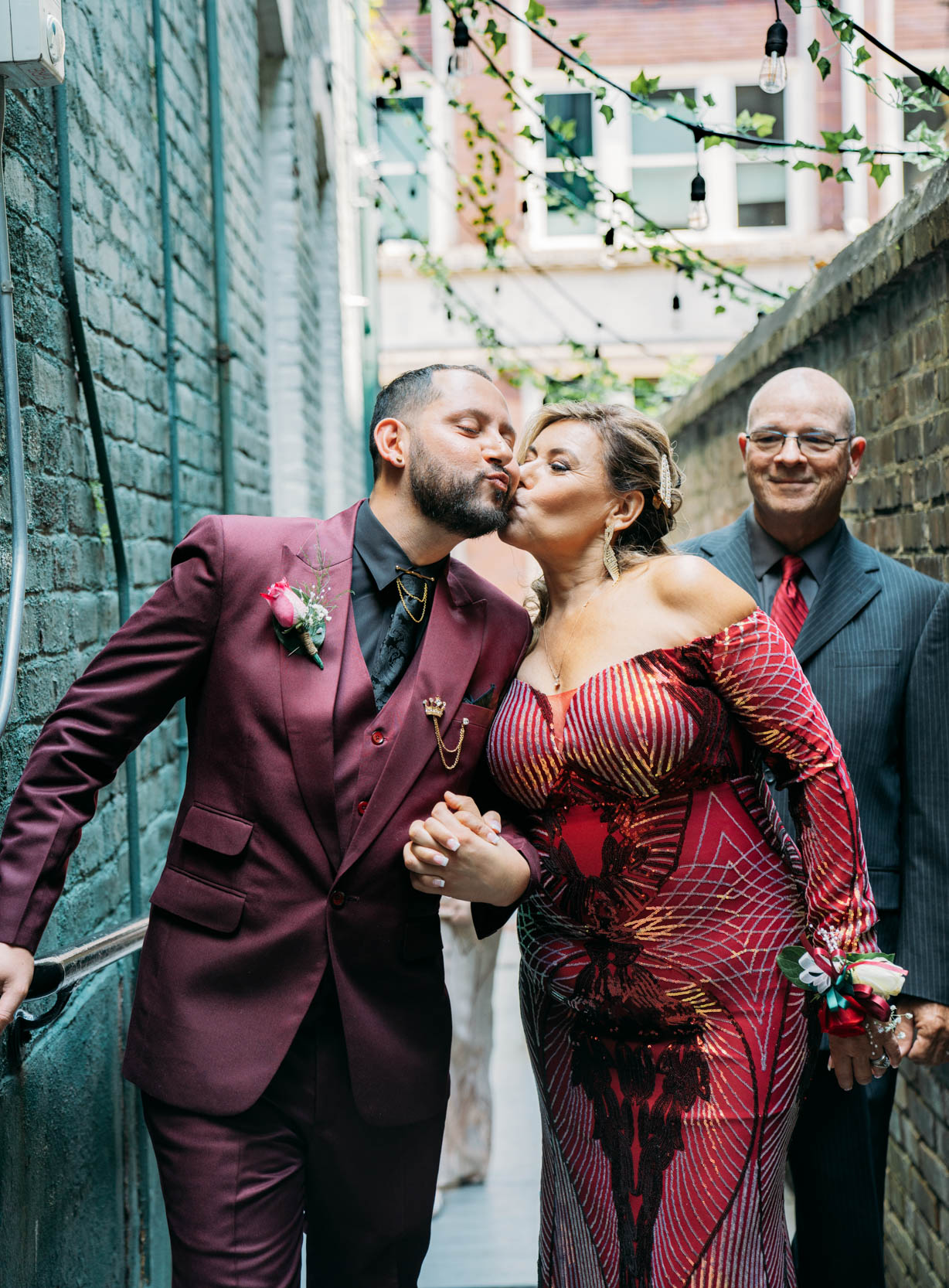 mother kissing her son on the cheek during a gay elopement ceremony at The Historic Swoop Duggins House in New Orleans