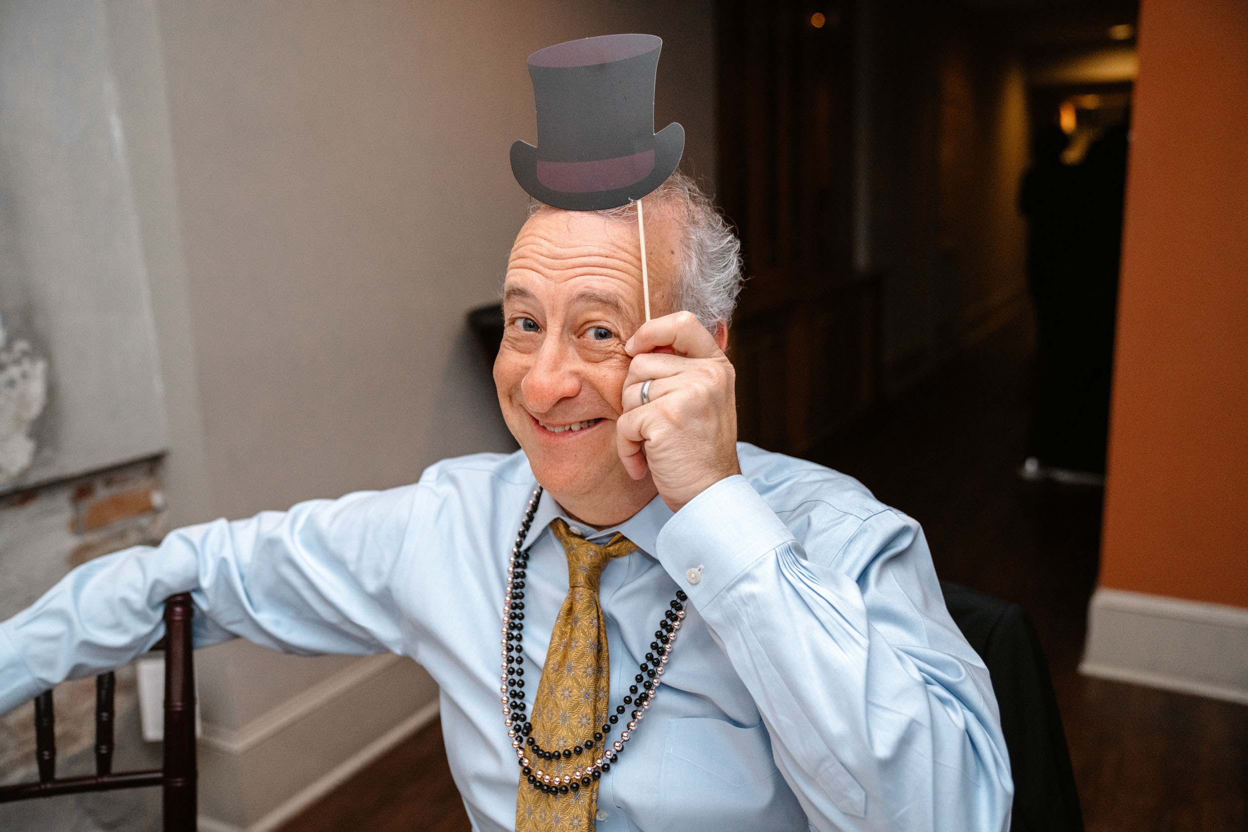 wedding guests holding a wedding prop during wedding reception at Hotel Mazarin in The French Quarter of New Orleans