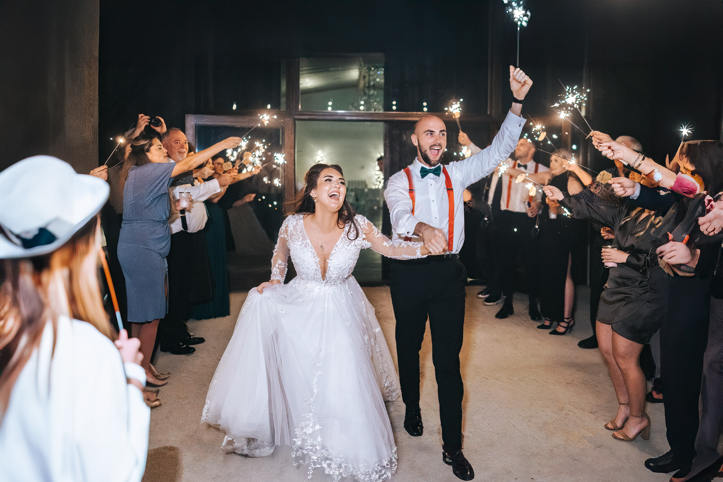 Bride and groom celebrating during sparkler exit at Creekview Barn in Mississippi