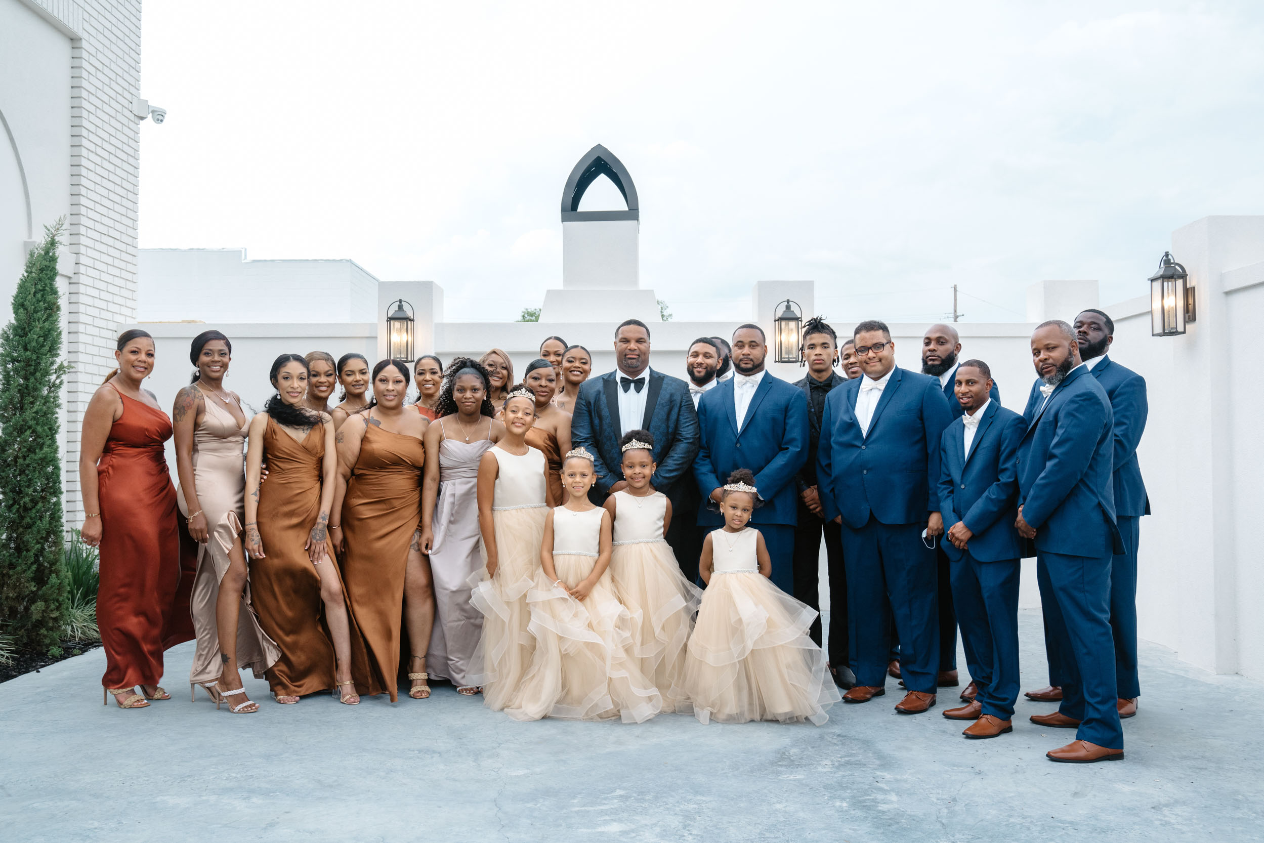 African American family portrait of groom and bride's families on wedding day at The Moore in Harahan, Louisiana