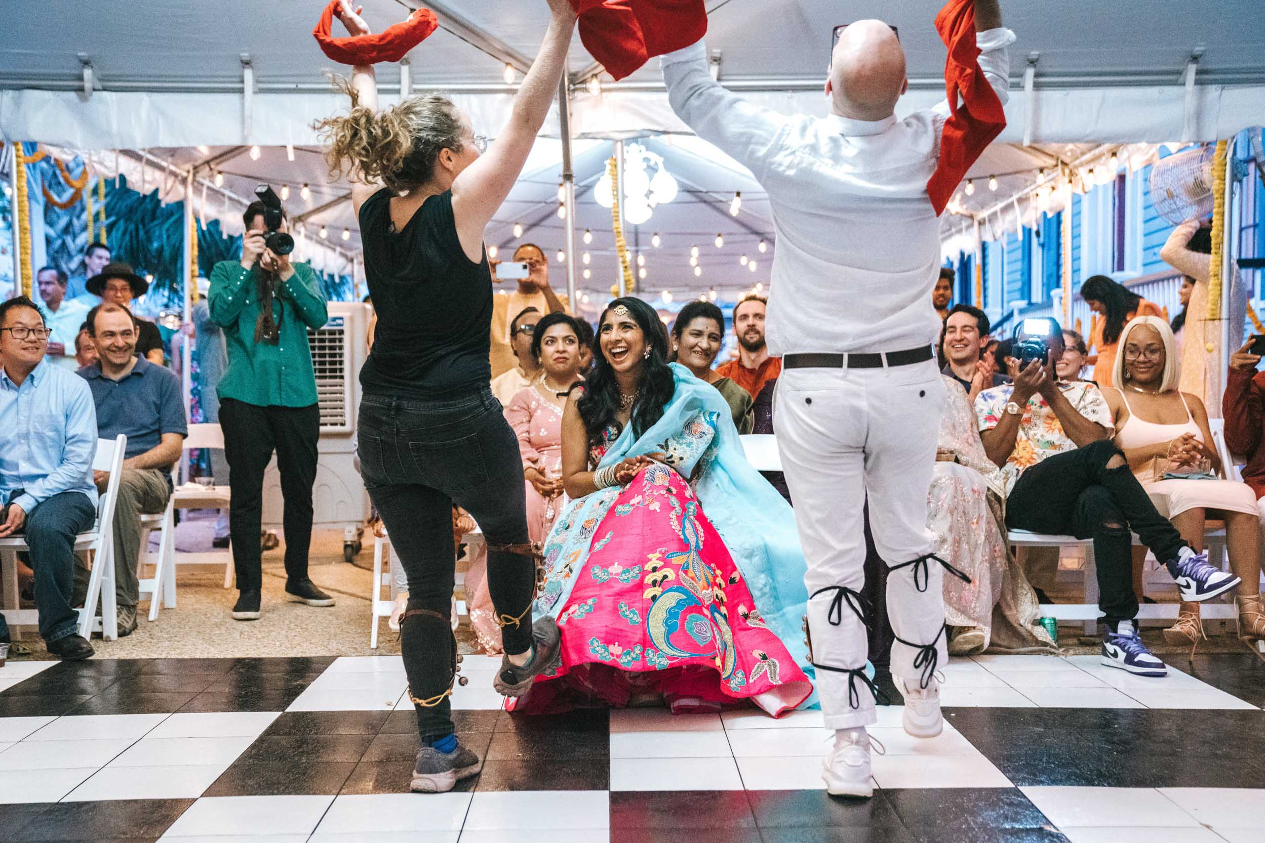 American Indian bride being entertained by wedding guests during Sangeet event at Derbès Mansion in New Orleans