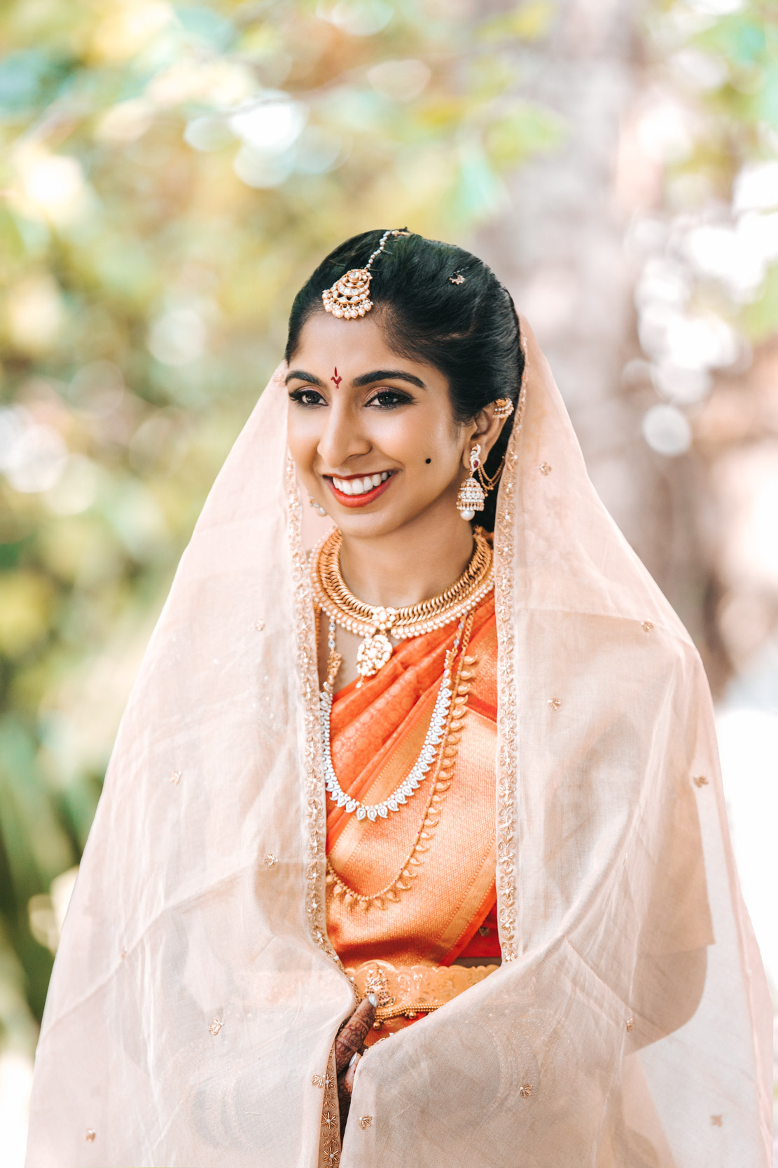 American Indian bride wearing veil and lehenga or a saree wedding dress for her nikah ceremony at Derbès Mansion in New Orleans