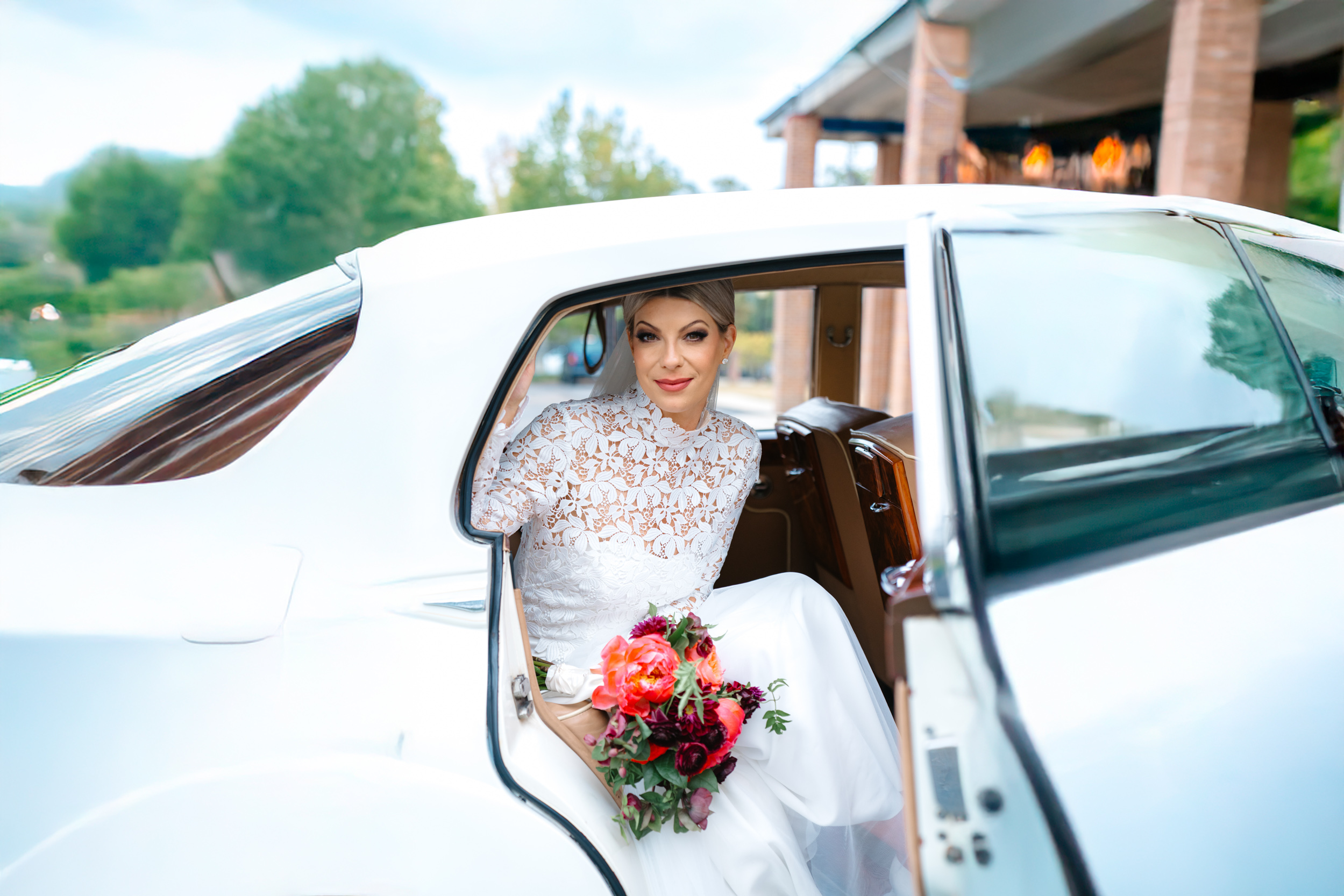Bride sitting in Rolls-Royce with Petals and Parties flowers on wedding day at the Southern Hotel in Covington, Louisiana