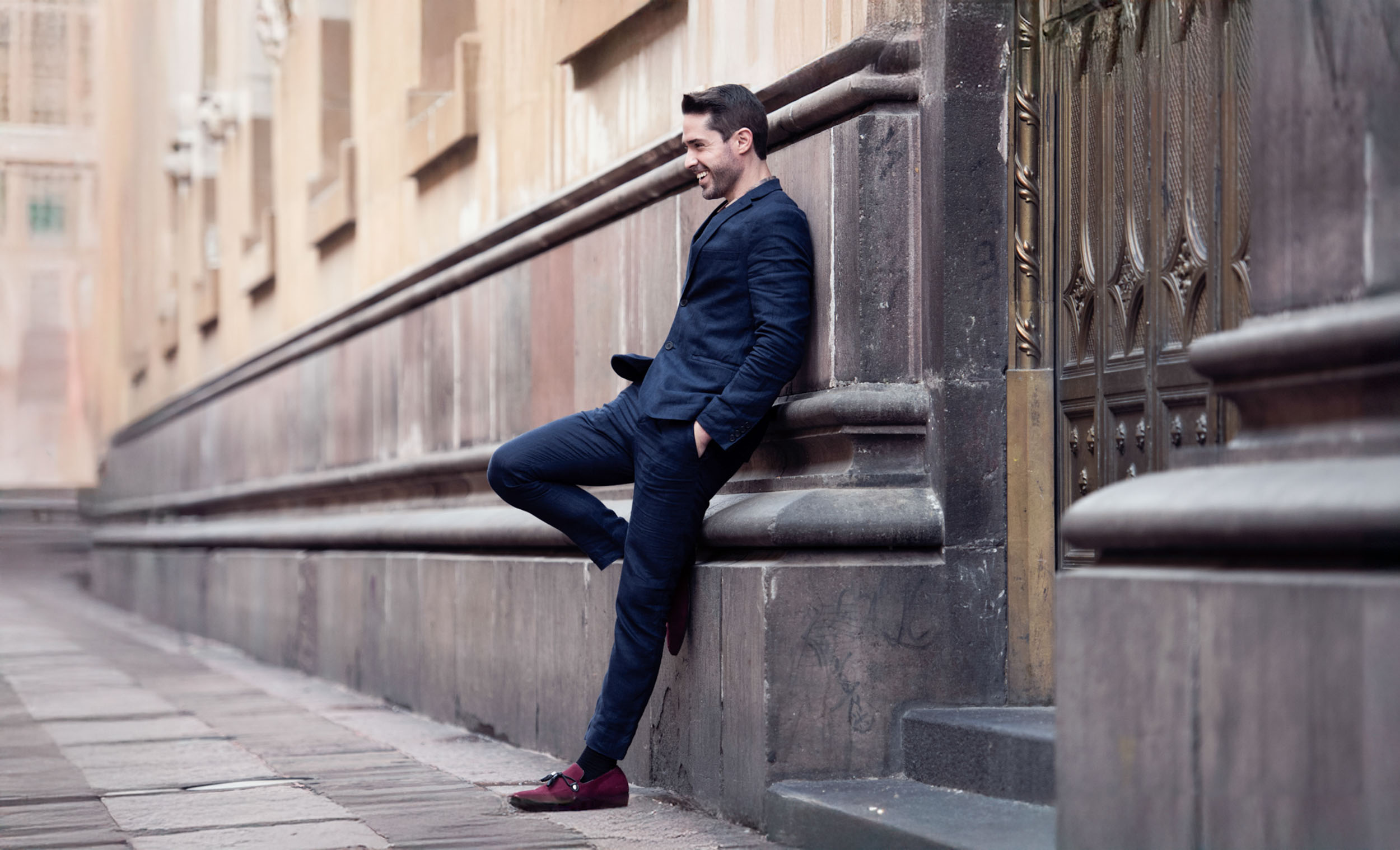 Ryan H Gray with Shades of Gray Photography smiling in alley way in Mexico City