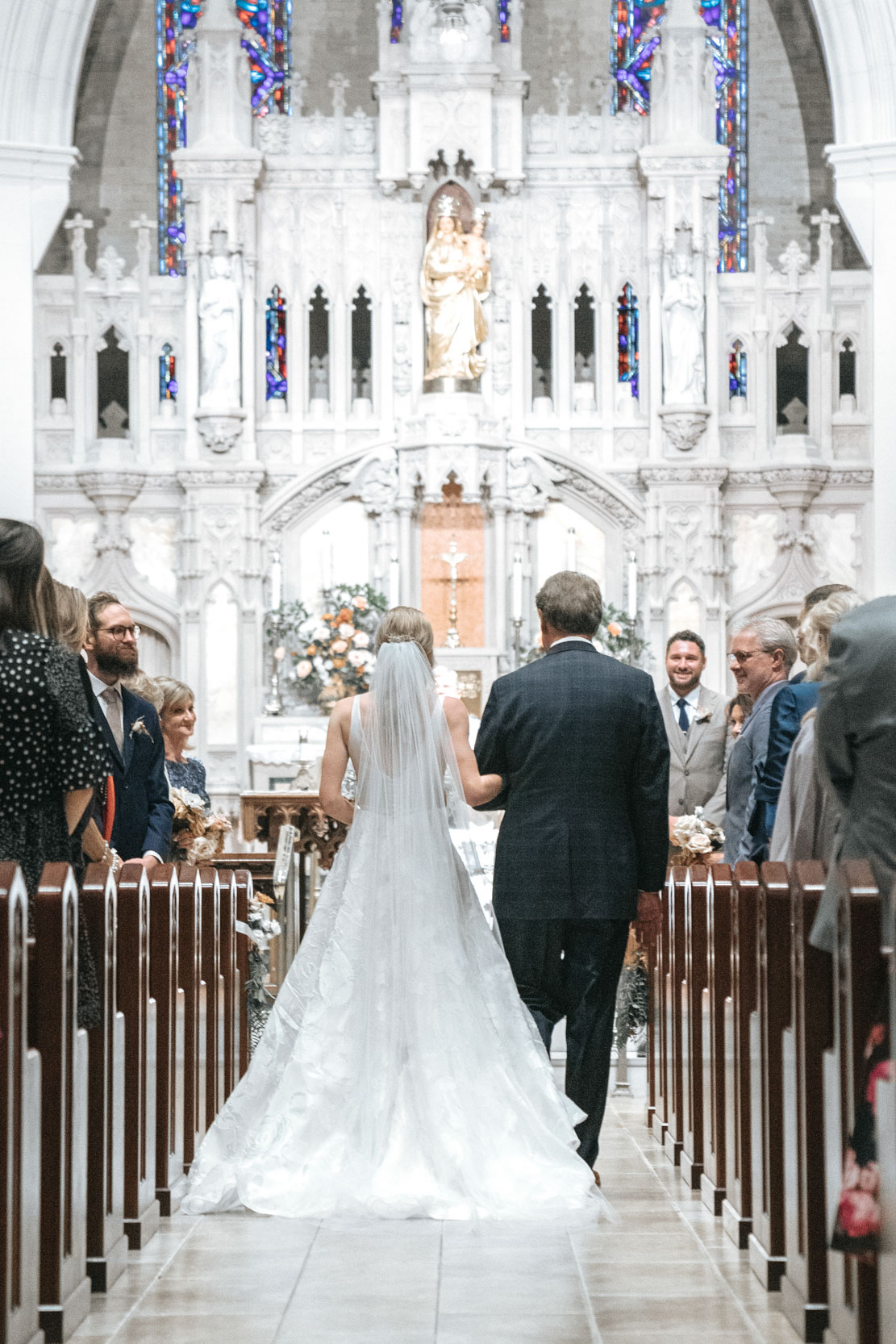 bride and father walking down aisle at Ursuline church in New Orleans