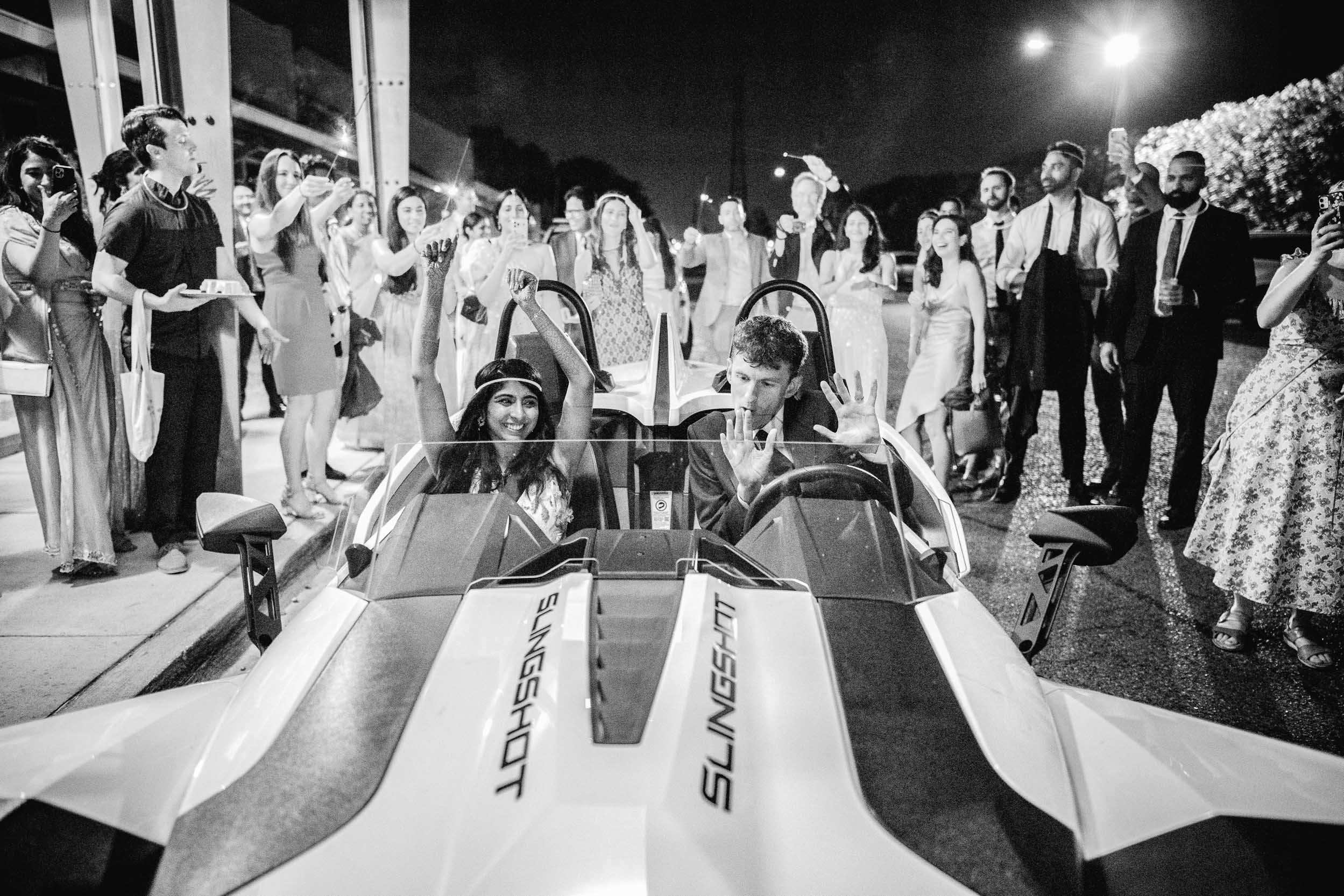 bride and groom exiting their wedding in a sports car at the Solomon Theater NOCCA in New Orleans