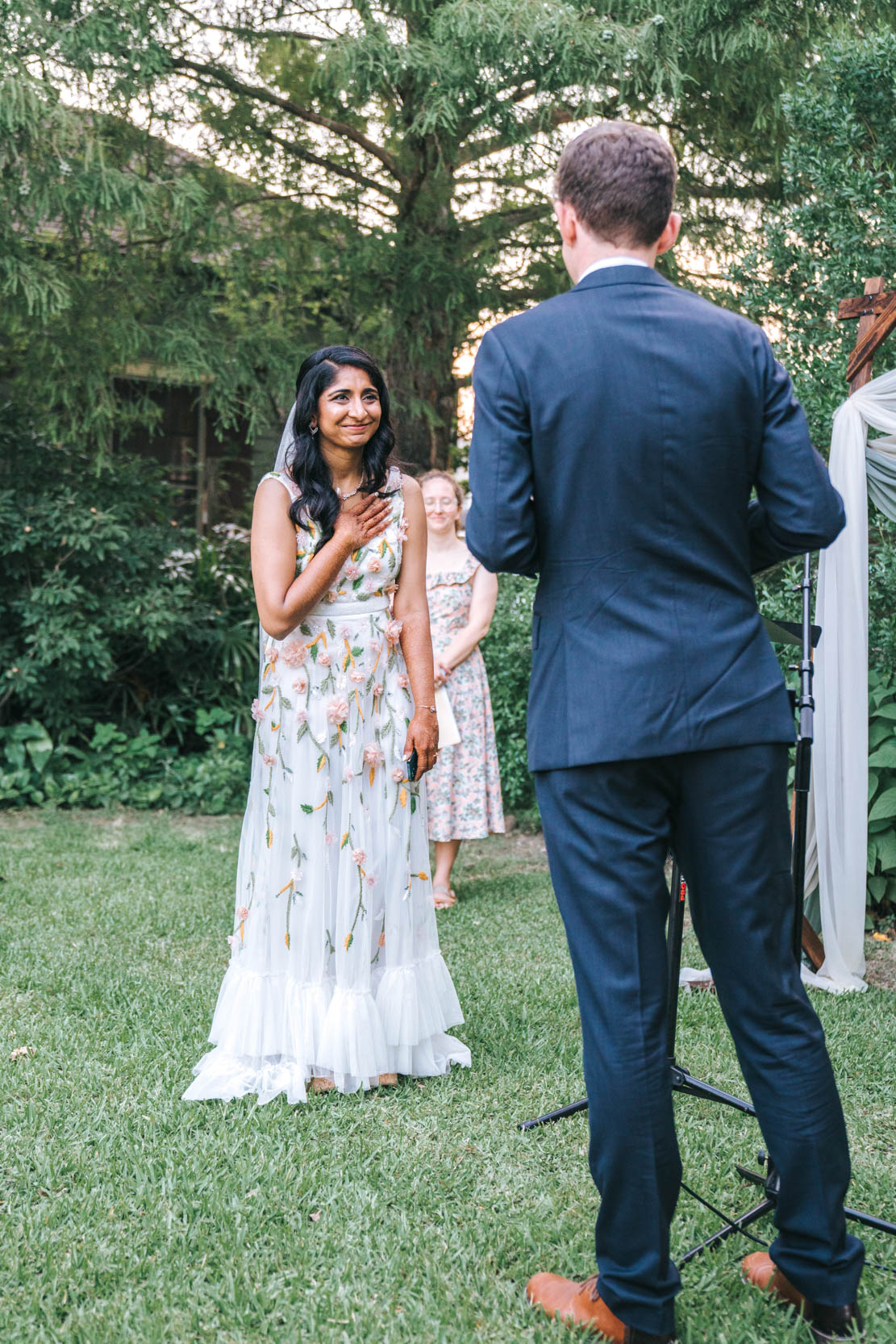 bride crying during wedding ceremony at Press Street Gardens in Bywater New Orleans