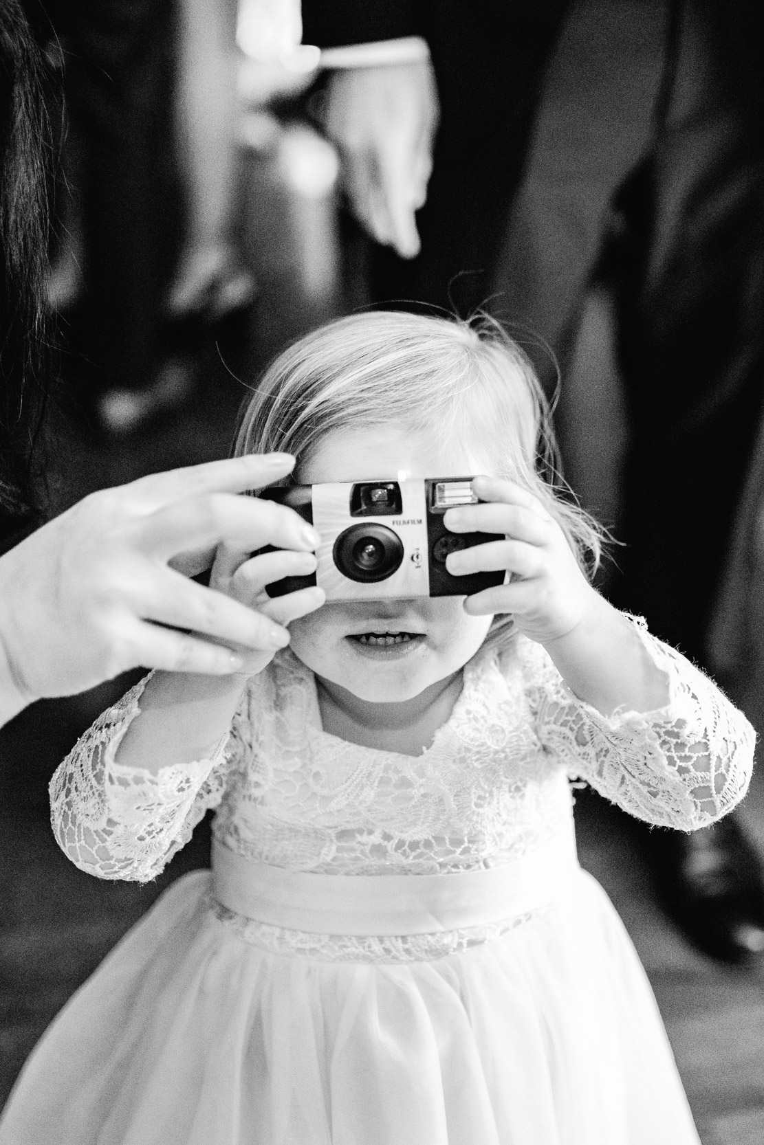 child holding polaroid camera during wedding reception at the Riverview Room in New Orleans