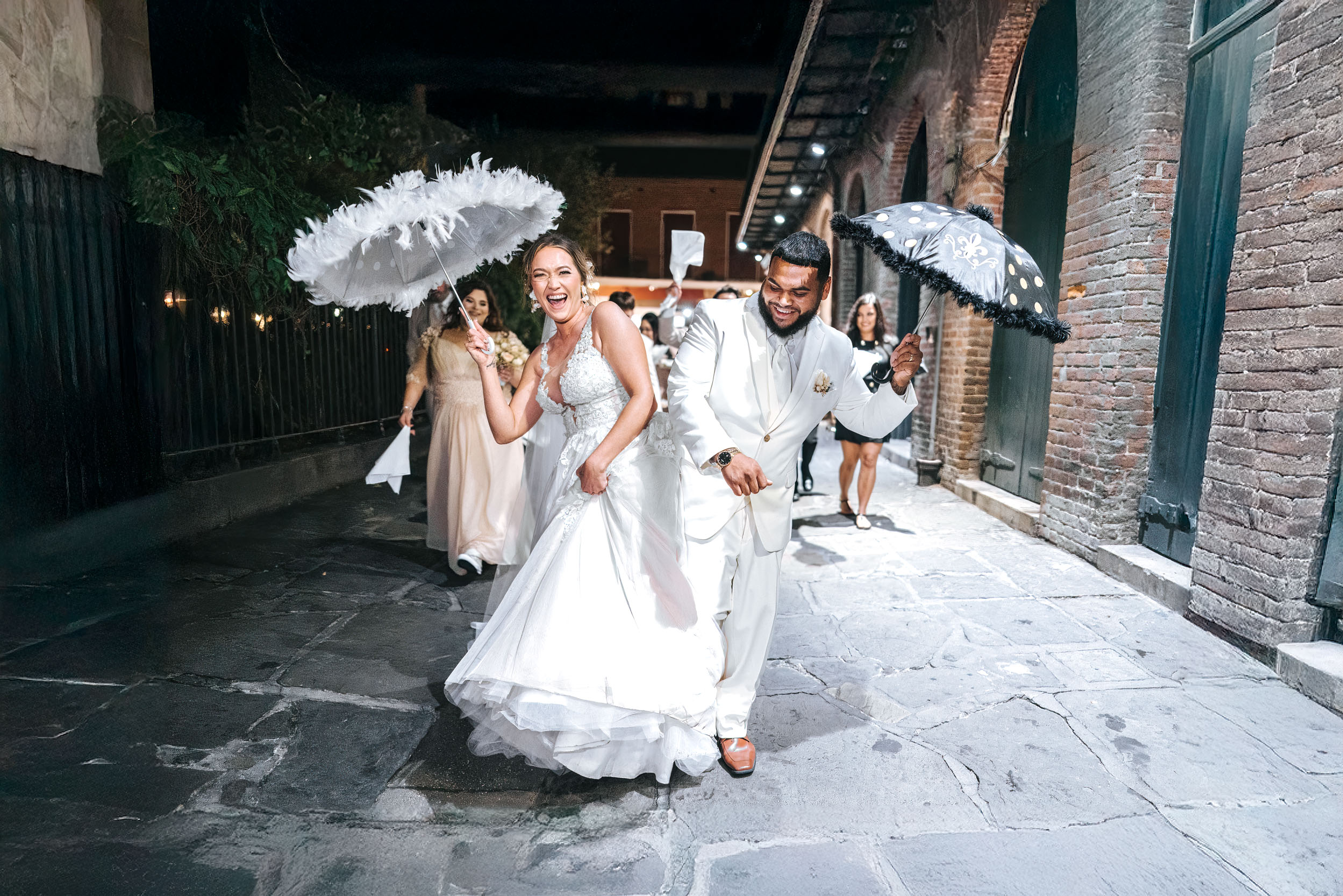 second line band parade on wedding day in French Quarter with parasols